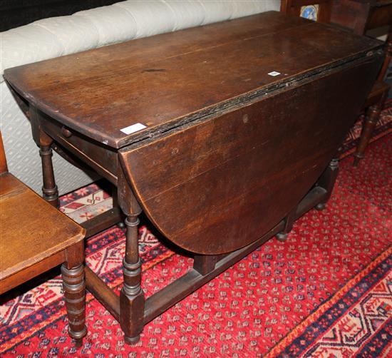 A 17th century style oak gateleg table on turned supports, L.117cm